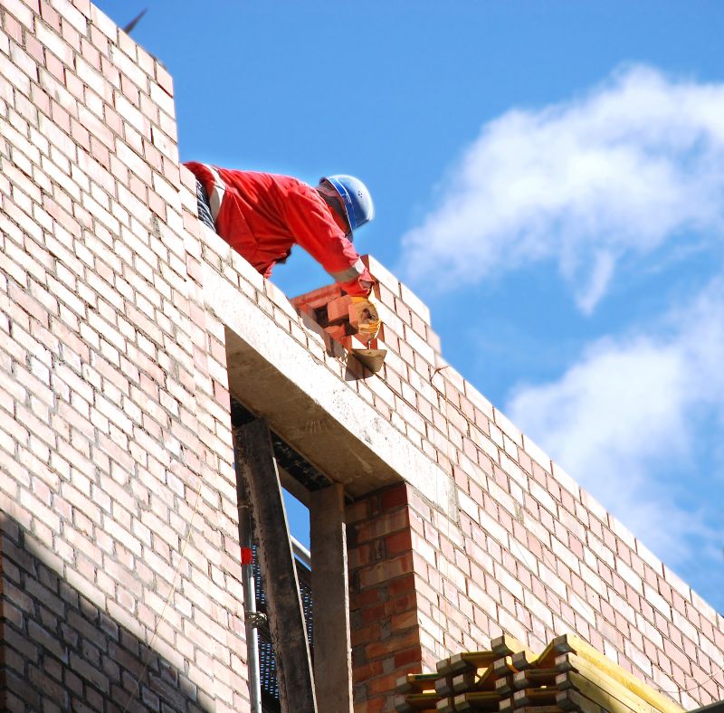 Masonry Worker Installing Brick Wall